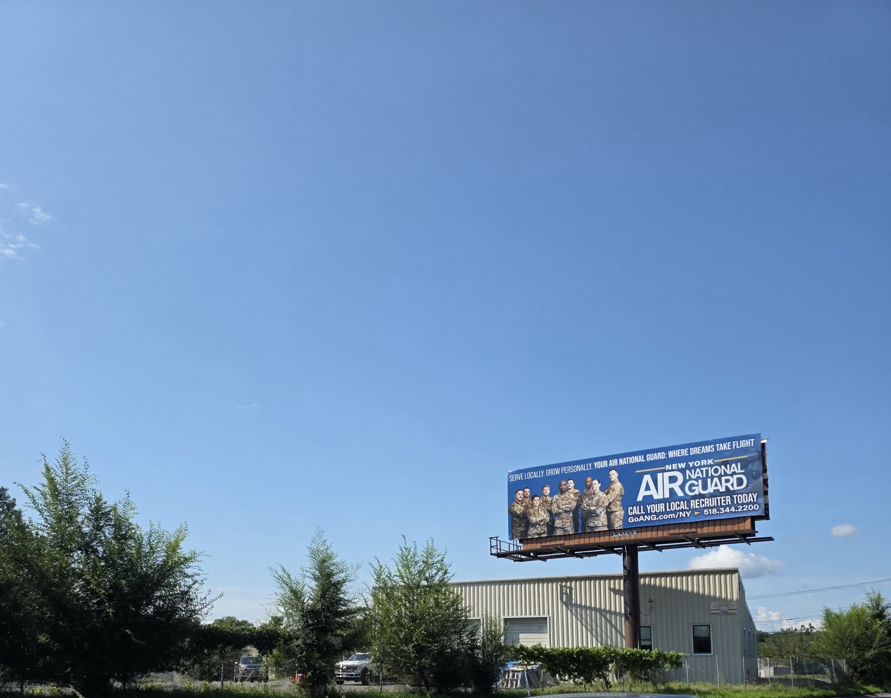 Air National Guard recruiting billboard encountered while driving to the old office and laboratory to empty the last Conex box of equipment, August 14, 2026. The billboard brought back an earlier Air National Guard flight-nurse interview and, from there, the much older attempt to join the Marines.