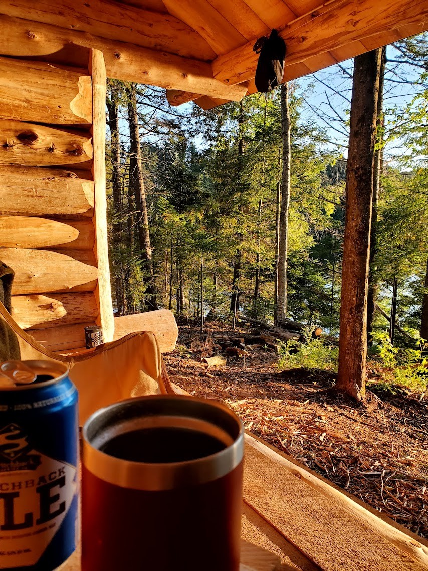 Cup and drink at the lean-to with the pond visible through the trees